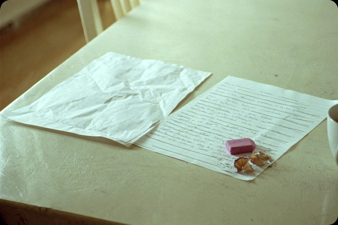 A crumpled list smoothed flat beside a fresh one, several lines crossed out